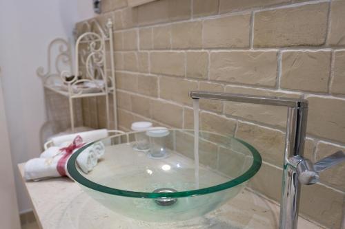 a glass sink on a counter in a bathroom at Dimora San Quirico - bed e breakfast - Cisternino in Cisternino