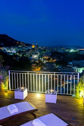 a balcony with a view of a city at night at Aquaboutique Wellness&Spa in Vietri sul Mare