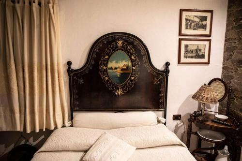 a bedroom with a bed with a mirror on the wall at Rooms Romangia in Sorso