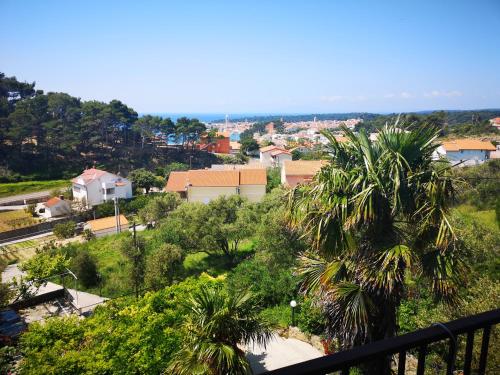 a view of a city from the balcony of a house at Rooms Vukušić in Rab