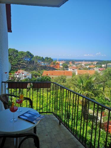 a balcony with a table and a view at Rooms Vukušić in Rab