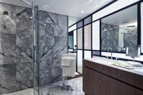 a bathroom with a shower and a sink at AthensWas Design Hotel in Athens