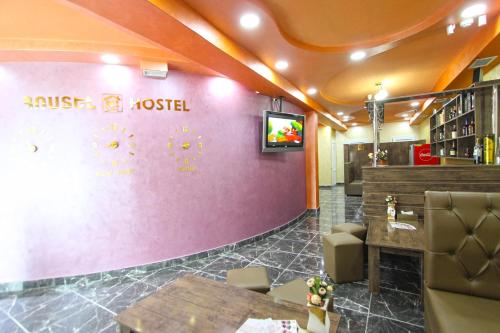 a restaurant with a pink wall with a sign on it at HOTEL N1 in Yerevan