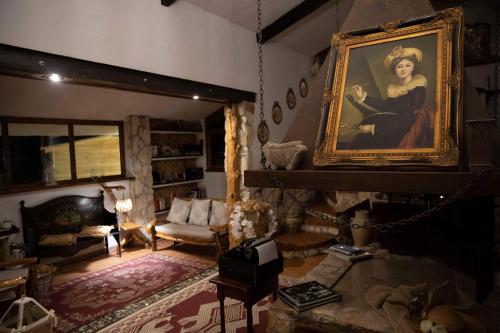 a living room with a painting of a woman at Rooms Romangia in Sorso