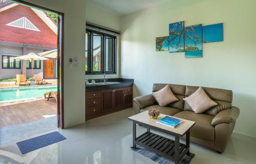 a living room with a couch and a table at The Scene Cliff View Villas in Ao Nang Beach
