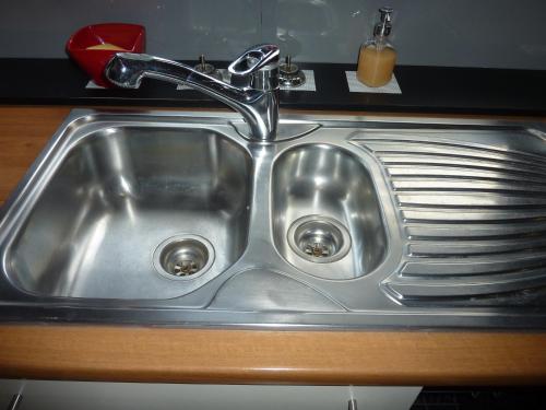 a stainless steel kitchen sink with a faucet at Vakantie woning De Loft in Dilsen-Stokkem