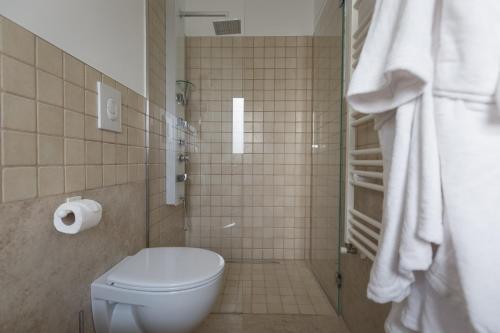 a bathroom with a toilet and a shower at Dimora San Quirico - bed e breakfast - Cisternino in Cisternino