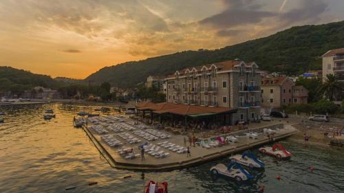 a group of boats parked in the water near a harbor at Hotel RR in Herceg-Novi