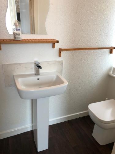 a bathroom with a white sink and a toilet at West Vale Villa in Blackpool