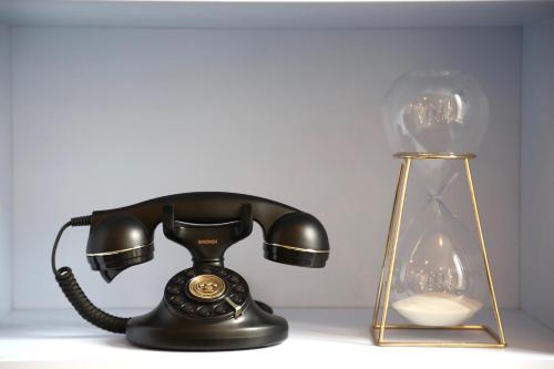 a telephone and a lamp on a table at Stella Etoile in Paris