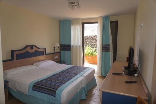 מיטה או מיטות בחדר ב-Casa "Villa Jandia I"