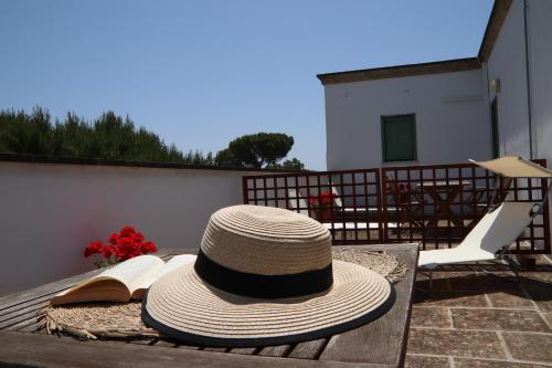 a hat and a book sitting on a table at Agriturismo Francesca Stajano in Alezio