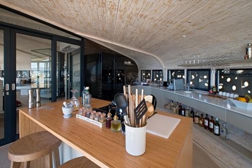a bar in a restaurant with a counter with bottles at Desert Whisper in Solitaire