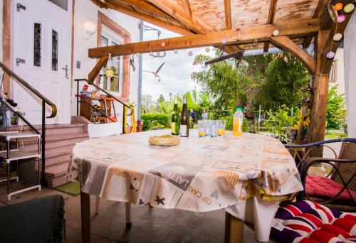 a table with wine bottles and glasses on a patio at "Chez Michele & Christian " in Barr