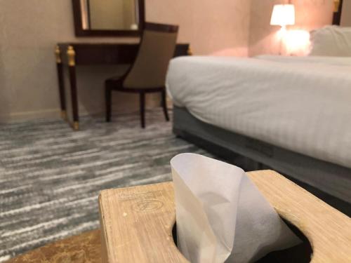 a hotel room with a bed and a napkin on a table at Concord Plaza in Hafr Al Baten