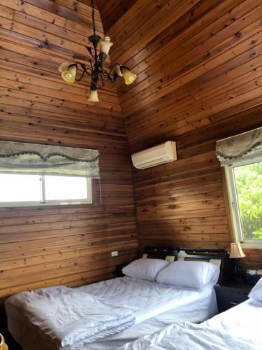Cama o camas de una habitación en Yiyue Guanhe Homestay 倚月觀荷民宿