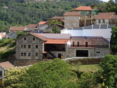 a building on a hill in a town at Casa Carolina in Vila Seca