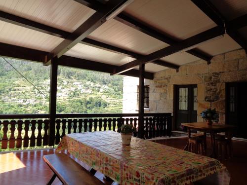a table on a balcony with a view of a mountain at Casa Carolina in Vila Seca