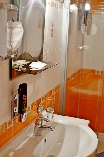 a bathroom with a sink and a shower at Penzion Daniela in Rajecké Teplice