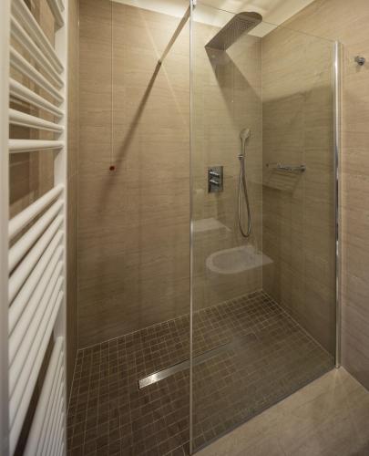 a bathroom with a glass shower with a toilet at Albergo Caffe Centrale in Mezzocorona