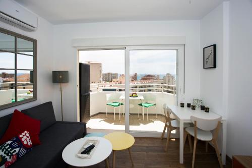 a living room with a couch and a table at MONKÓ LOVELY, QUIET & CENTER SEA VIEWS o in Torremolinos