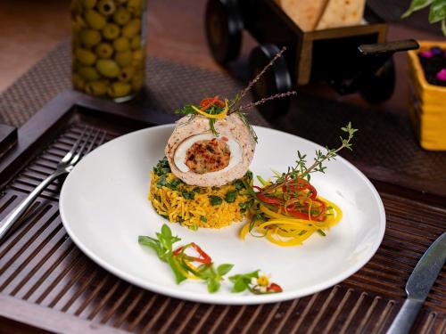 a white plate with food on a table at The Orchid Hotel Hinjewadi Pune in Pune