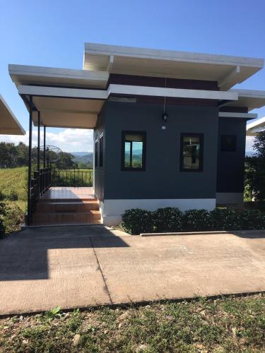 a blue house with a pathway leading to it at Thungchanghill Resort in Nan