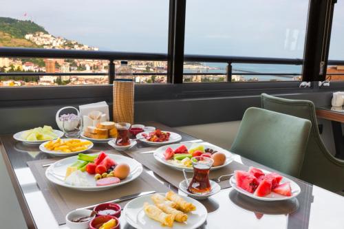 a table with plates of food on it with a view at Azra Suite Otel in Trabzon