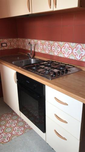 a kitchen with a stove and a sink at Villa belvedere in Pontecagnano