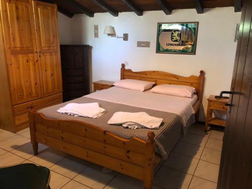 a bedroom with a bed with two towels on it at Oasis in Skiathos