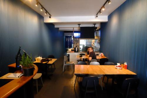 a person sitting at a table in a restaurant at Every Surawong in Bangkok