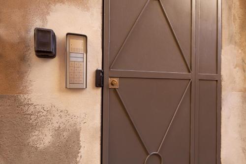 a door with a cell phone plugged into it at "Vicolo Apartment" is a Two-story Apartment, 2BDR, additional Sofabed, 2,5 BTH, Aircondo, Pedestrian Centre, Private Parking 600mt far, easy to train and ferries, city life in La Spezia