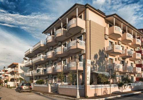 a building with balconies on the side of it at INO Luxury Rooms in Paralia Katerinis
