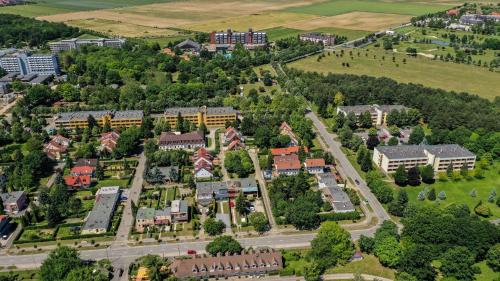 an aerial view of a campus with buildings and trees at Apartman Hotel in Bük
