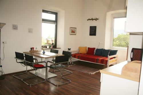 a living room with a couch and a table and chairs at Alte Volksschule - schual in gradne in Liebenfels