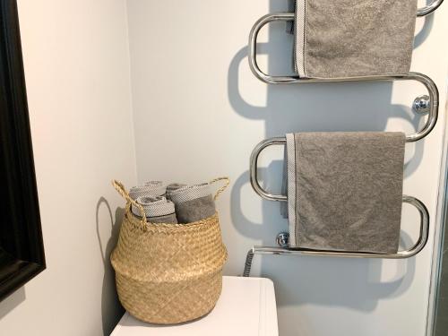 a bathroom with towels hanging on a wall at Patogus Miegas IV in Anykščiai