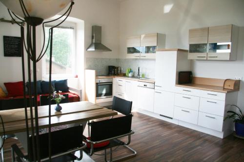 a kitchen with a table and a dining room at Alte Volksschule - schual in gradne in Liebenfels