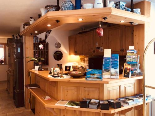 a kitchen with a counter with books on it at Hotel Berghof in Nauders