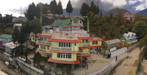 a large building with colorful houses on top of it at Dolma in Tawang
