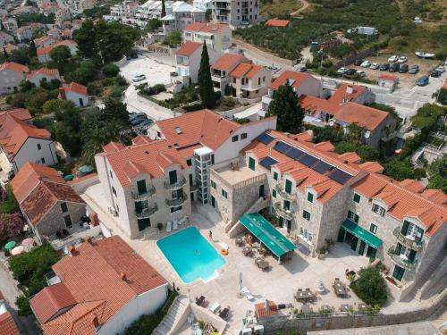 an aerial view of a house with a swimming pool at Hotel Ivan Dujmović Dvori in Bol