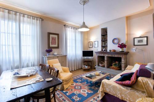 a living room with a couch and a table at Appartamenti Belvedere in Cortona