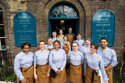 a group of people standing in front of a building at Aragon House in London