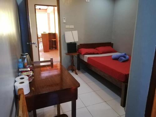 a bedroom with a bed and a table and a mirror at West Atlantic Inn in Concepcion