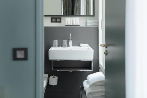 a bathroom with a white sink and a mirror at XO Hotel Paris in Paris