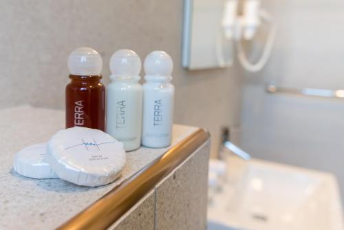 three bottles of liquid sitting on a counter in a bathroom at Boutique Villa Filaus in Dubrovnik