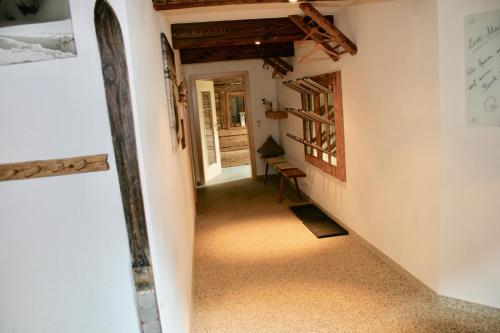 a hallway of a house with a table and a chair at Appartements "Da Zillertaler und die Geigerin" in Mayrhofen