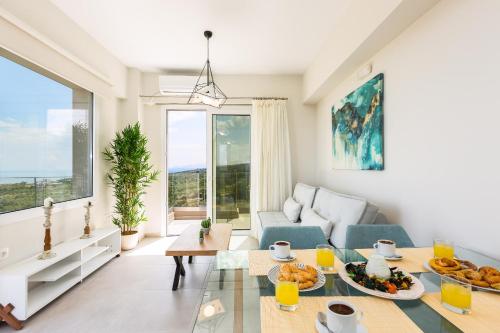 a living room with a table and a couch at Vigla Suites in Rethymno Town