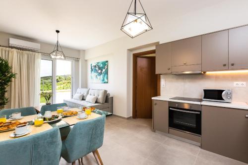 a kitchen and living room with a table and chairs at Vigla Suites in Rethymno Town