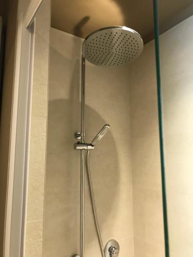 a shower with a shower head in a bathroom at Luigi in Palazzo Bianchi in Parma