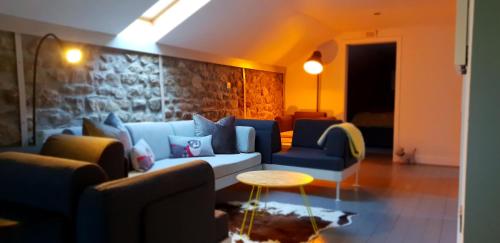 a living room with a couch and a table at Hawks Barn in Horton in Ribblesdale